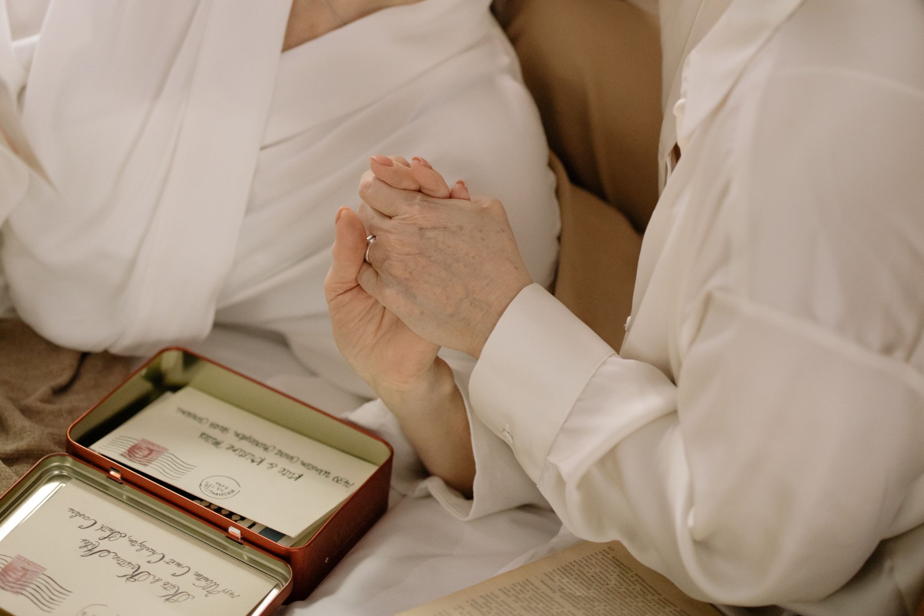 Older people holding hands in support